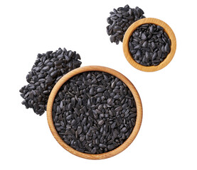 black sunflowers seeds in a wooden bowl  isolated on a white background, top view.