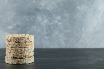 Stack of puffed rice cakes on marble background