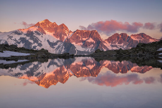Clouds and Peaks at Dawn Reflected in the Frati Lake, Italian Alps, Valcamonica, Lombardy, Italy 