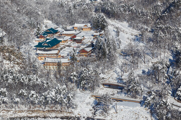 Alpencia, South Korea, 2016, Winter - Top View. Buddhist monastery in the middle of a snowy forest in the winter taiga.