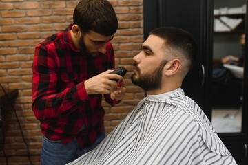 Bearded man, bearded male. Vintage barbershop, shaving. Portrait of stylish man beard. Barber scissors and straight razor, barber shop. Beard styling. Advertising barber shop concept. Black and white