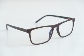 Optical glasses in a dark frame on a white background. Copy, empty space for text