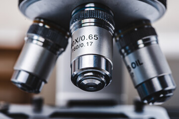 Close-up shot of professional scientific microscope with metal lens setting at medical laboratory, Modern technology equipment for medicine science research in term of biology chemistry education