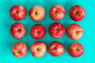Fruit pattern of red apple on blue background. Flat lay, top view. Pop art design, creative summer concept. Food background.