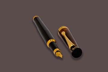 Black fountain pen with cap. .Pen isolated on dark background.