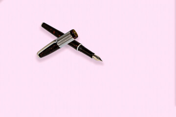 Business fountain pen isolated on pink background.