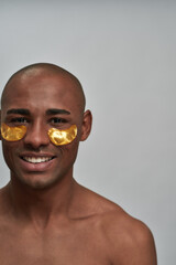 Cosmetic eye masks lying on a multiracial male face