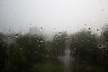 Water drops on window glass, close up, autumn mood, selective focus