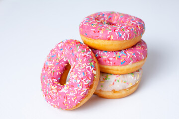 Delicious Pink and white doughnuts close up on a white background