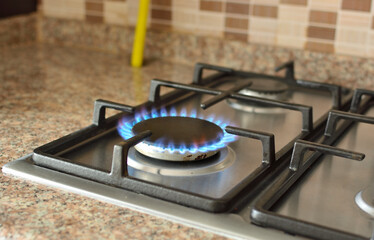 Modern kitchen stove cook with blue flames burning, gas burner.