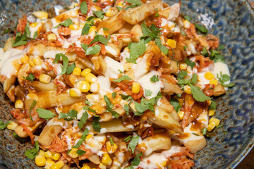 A delicious bowl of classic British chips or fries with gravy and garish.
