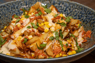 A delicious bowl of classic British chips or fries with gravy and garish.