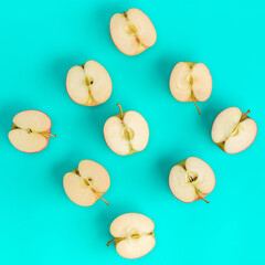 Fruit pattern of apple halves on blue background. Flat lay, top view. Food background. .  Pop art design, creative summer concept.