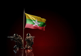 Concept of military conflict. Waving national flag of Myanmar. Illustration of coup idea. Two soldier statue guards defending the symbol of country against red wall - obrazy, fototapety, plakaty