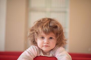 little baby girl with strange hairstyle and curlers