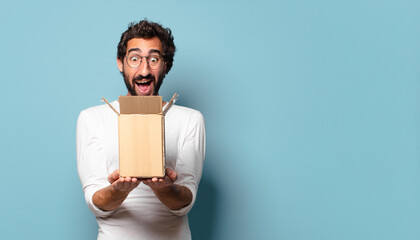 young crazy bearded man recibing a cardboard package