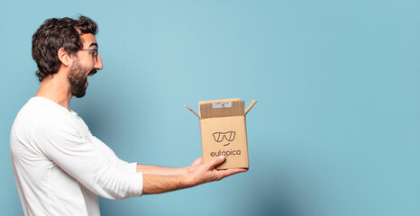 young crazy bearded man recibing a cardboard package