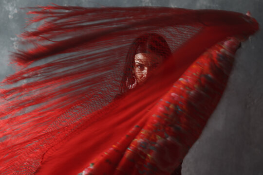 Young Adult Spanish Woman Dancing Flamenco On Gray Vintage Background