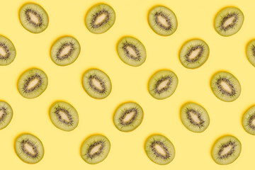 Kiwi slices pattern on green background. Food background. Fruit pattern.  Pop art design, creative summer concept.