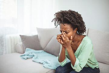 Female with mood disorder having a headache. Young hopeless woman suffering from depression having...