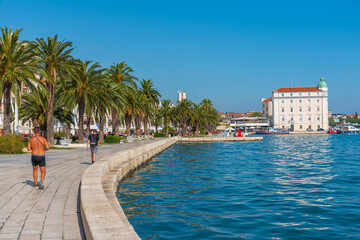 People are walking on seaside promenade in Split, Croatia