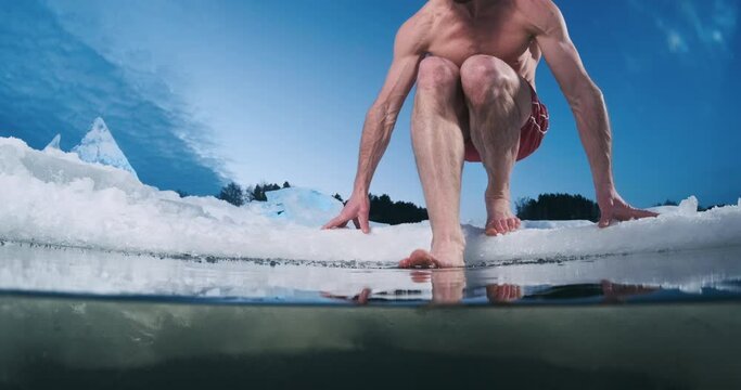 Winter swim. Young fit man swims in the icy water
