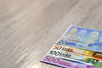 Euro banknotes on a wooden background 