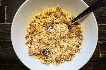white bowl with breakfast cereals and spoon