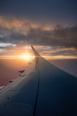 Beautiful view of sunset and clouds from inside window aircraft