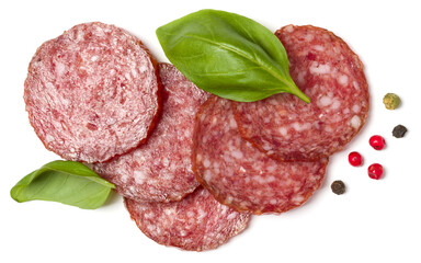 Slices of salami isolated on white background closeup. Sausage and basil leaves top view.