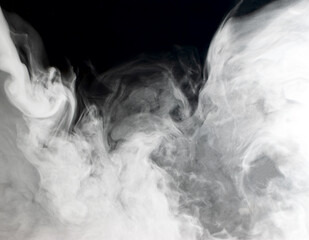 Abstract background of chaotically mixing clouds of white smoke against a background of darkness