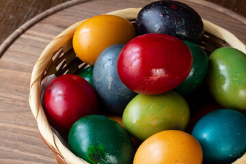 Easter eggs and Easter bun with flowers - wood background