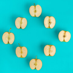 Fruit pattern of apple halves on blue background. Flat lay, top view. Food background. .  Pop art design, creative summer concept.