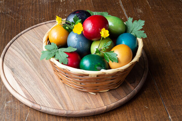 Easter eggs and Easter bun with flowers - wood background