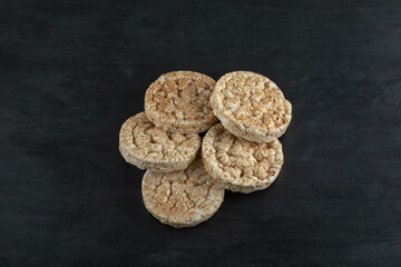 Crispy rice cakes on black wooden background