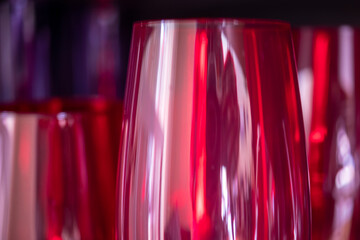 Standing wine glasses in different colors, abstracted and produced with macro technique