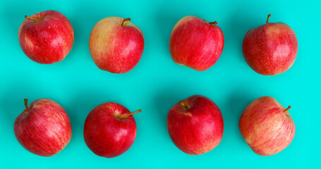 Fruit pattern of red apple on blue background. Flat lay, top view. Pop art design, creative summer concept. Food background.