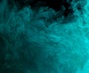 Fototapeta na wymiar Abstract background of chaotically mixing clouds of turquoise smoke on a background of darkness