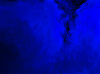 Abstract background of chaotically mixing puffs of blue smoke on a dark background