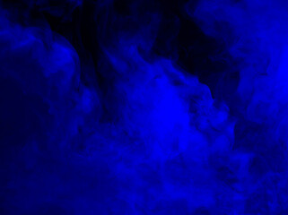 Abstract background of chaotically mixing puffs of blue smoke on a dark background