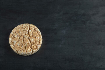Broken rice cake on big black background