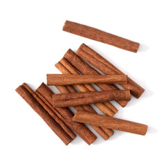 Cinnamon sticks isolated on white background closeup. Canella spice. Aromatic condiment background. Flat lay, top view.