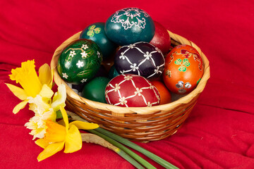 Easter eggs and Easter bun with flowers - red background