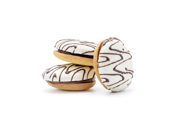 cookie with white icing and chocolate rows isolated on white background. sweet cake cut out