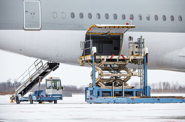 Preparing the aircraft before flight. Loading of baggage. Loading of cargo. Loading platform of air freight to the aircraft.