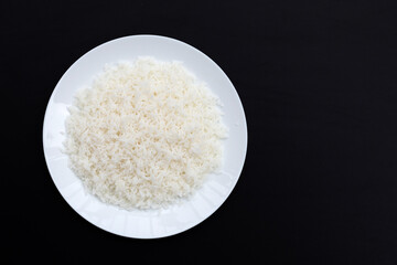 Dish of rice on dark background.