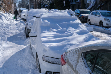 City street and cars covered in snow after snowfall