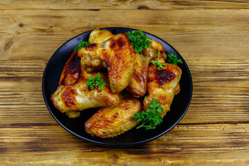 Baked chicken wings on a wooden table