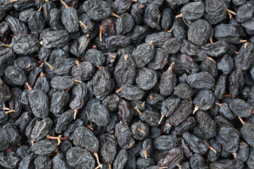 Black dried grapes on a white background