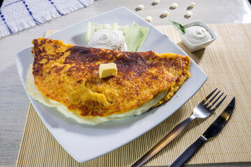 Comida típica de Venezuela servido en plato para restaurante, cachapas con relleno de queso jamón, cochino frito